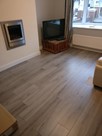 New grey laminate flooring and Torus skirting