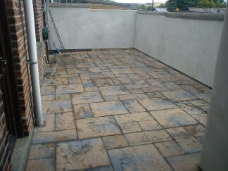 Bomb Site to Flagged back yard & rendered walls